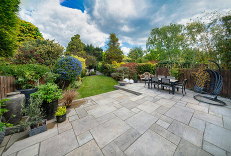 A stone paved patio and garden
